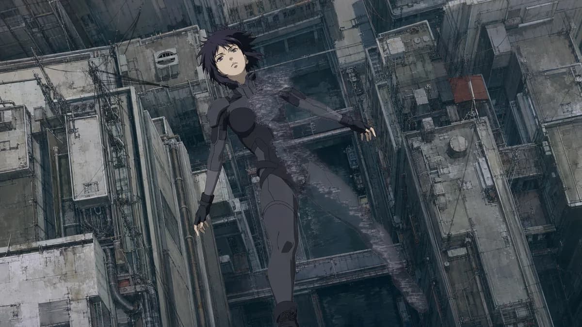 Motoko Kusanagi falling backwards from a tower into the city as her body turns transparent.
