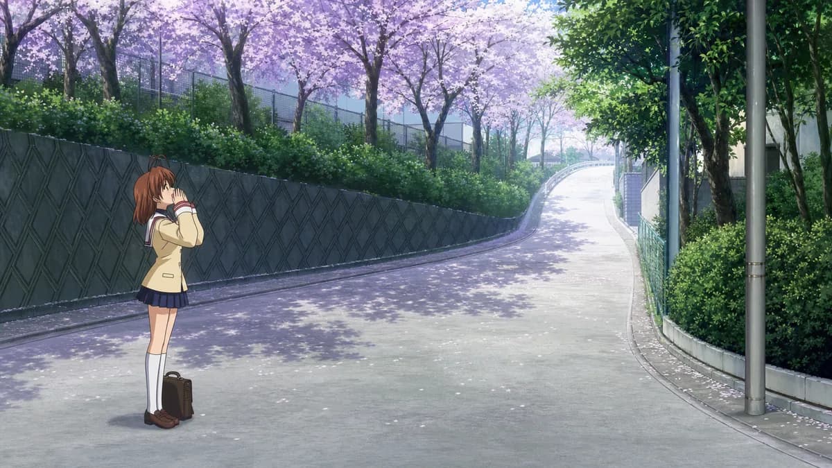 Nagisa standing alone at the bottom of the school hill, calling up to someone out of frame.